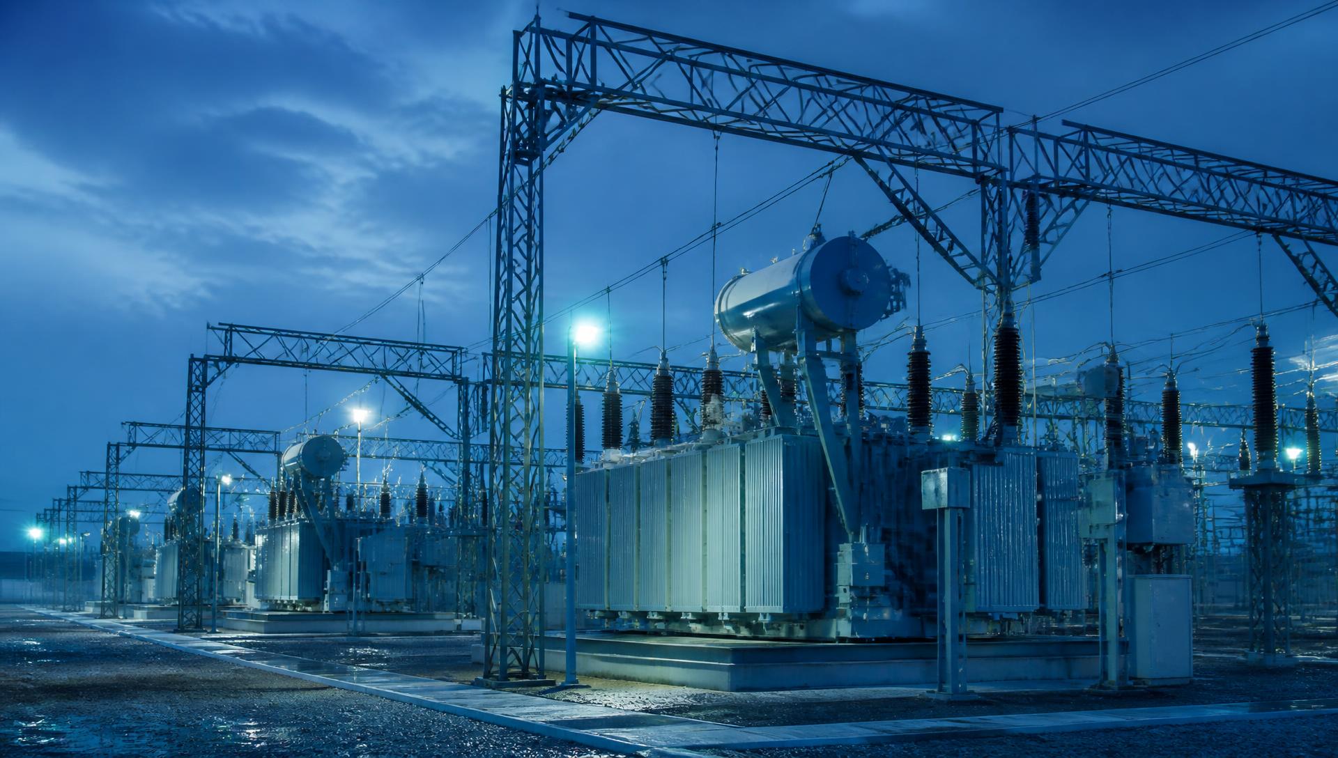 High-voltage substation with power transformers at dusk