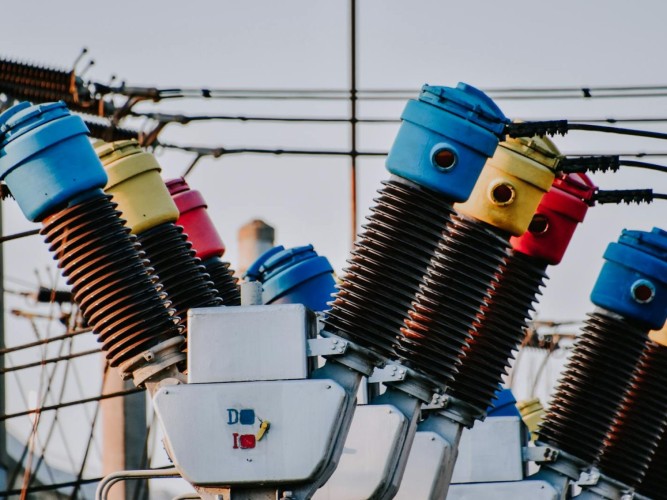 Colorful high voltage insulators in an electric substation highlighting power infrastructure.